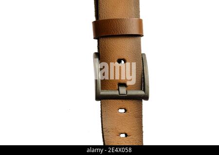 Old Brown leather belt isolated on white background. Worn Men`s belt. Leather belt with metallic clasp. Clothes accessory. Stock Photo